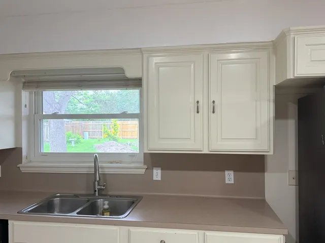 Before: the sink wall and laminate counters