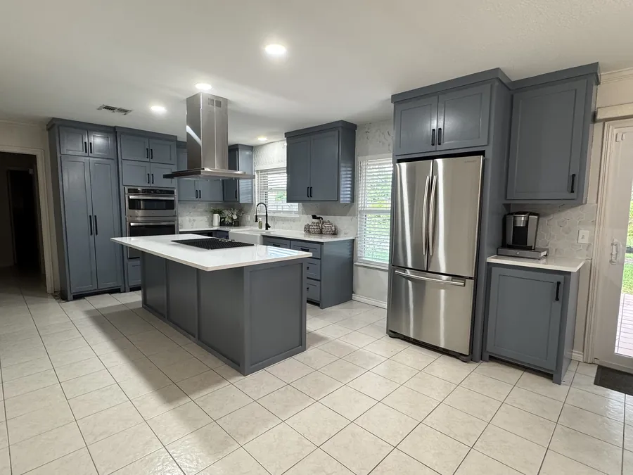 The finished slate-blue kitchen