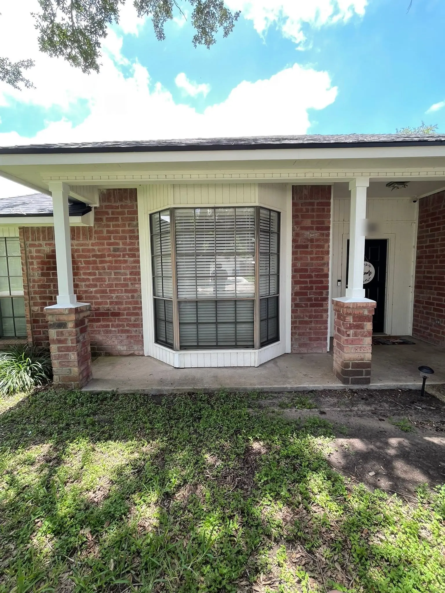 Brick house with new white porch column wraps