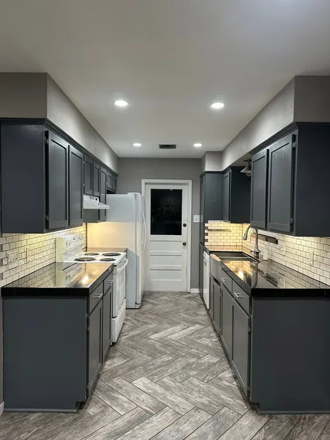 Before: Dark slate cabinets down both sides of the galley.
