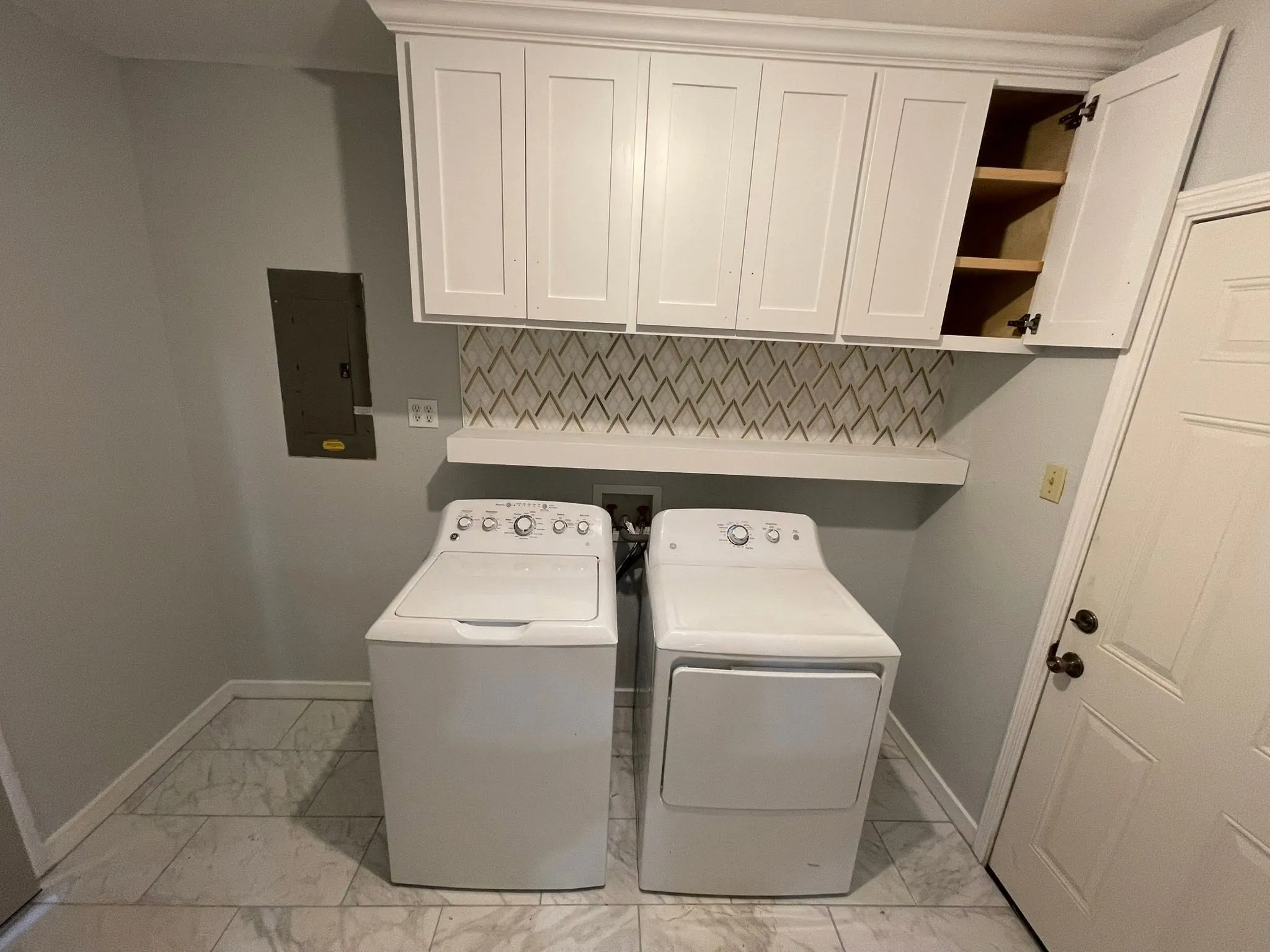 Laundry room remodel with new cabinets and a tile backsplash