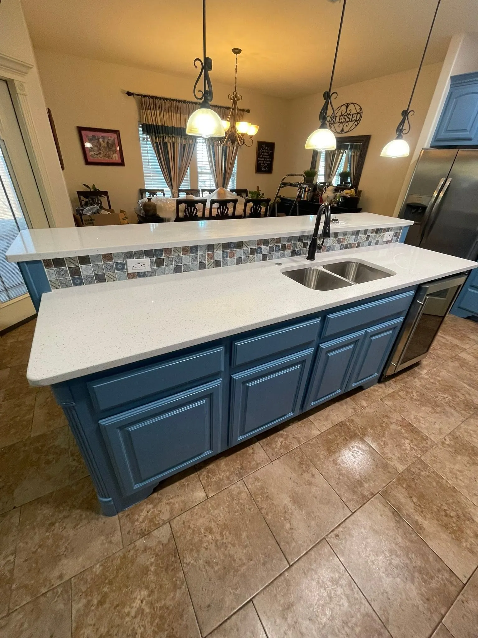 Kitchen with painted blue cabinets and a new countertop