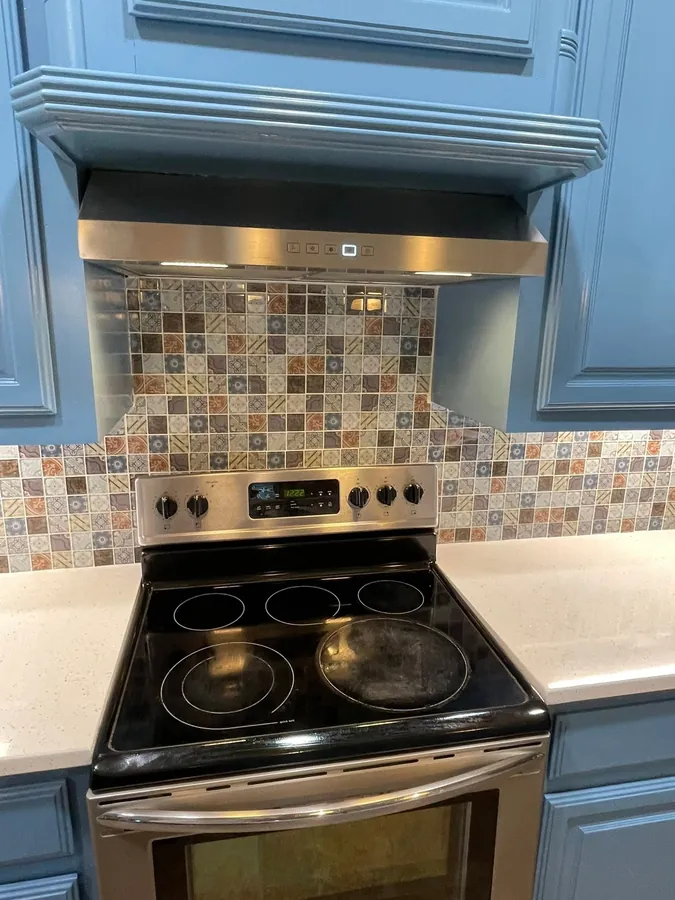 Vent hood over a patterned tile backsplash