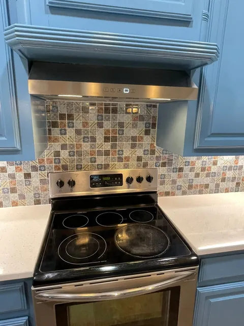 Vent hood over a patterned tile backsplash