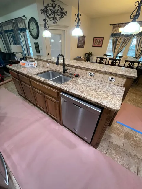 The kitchen before: brown cabinets and granite