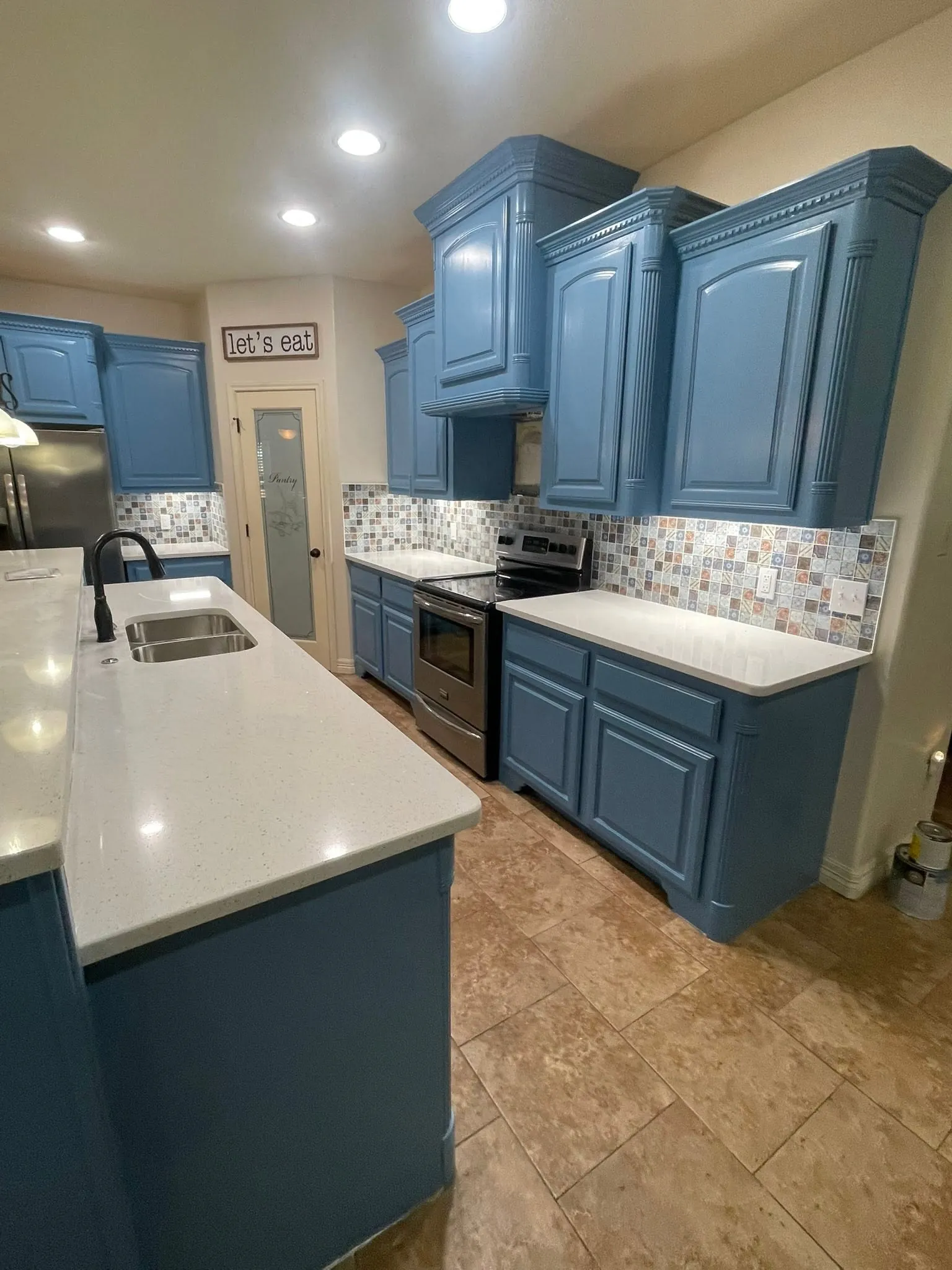 Corpus Christi kitchen with painted blue cabinets, a patterned tile backsplash and new countertops