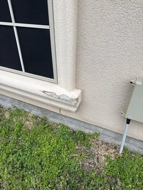 The damaged stucco before the repair