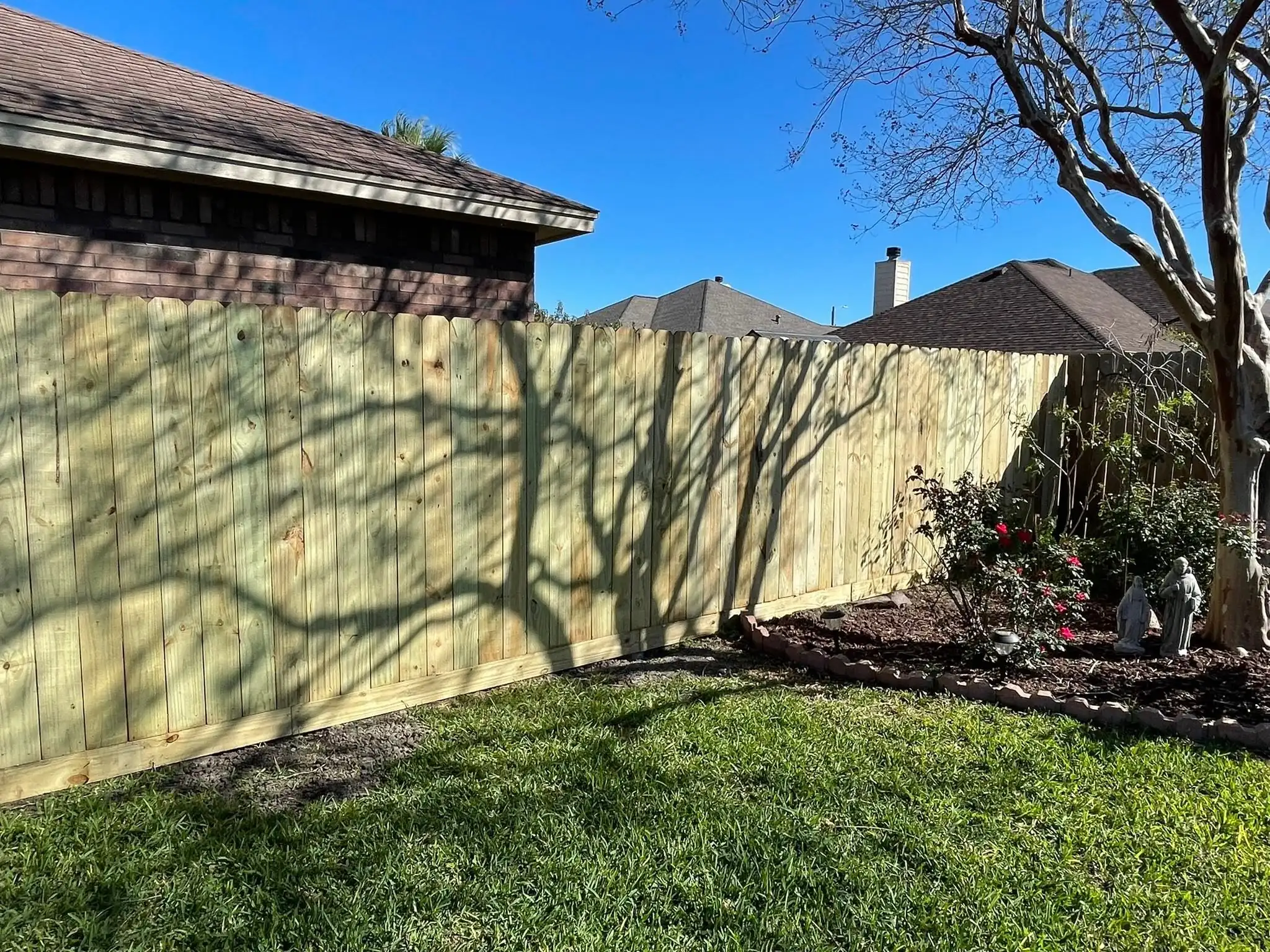 New wood privacy fence across a backyard