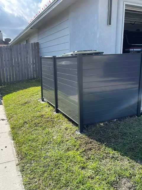 Metal trash-can enclosure on the new slab