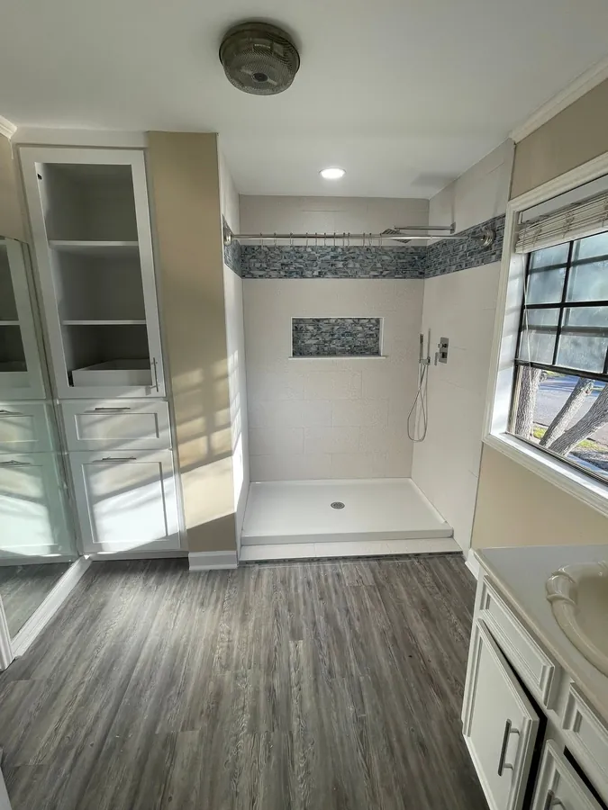 Finished tile shower with a mosaic band